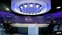 Delegates sit at a roundtable during a plenary session during the UK Artificial Intelligence (AI) Safety Summit at Bletchley Park, in central England, on November 2, 2023.