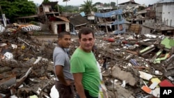 FILE - Neighbors watch a bulldozer demolish earthquake-damaged homes in Pedernales, Ecuador, Saturday, April 23, 2016. 