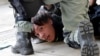 A protester is detained by riot police officers during an anti-government demonstration in Hong Kong, China, Nov. 10, 2019. 