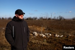Grain farmer Andrii Povod stands beside his field that has been damaged by shelling and trenches, amid Russia's invasion of Ukraine, in Bilozerka, Kherson region, Ukraine, February 20, 2023. (REUTERS/Lisi Niesner)