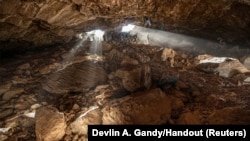 Researchers entering at a cave in Zacatecas in central Mexico, which contained stone tools and other evidence of the presence of prehistoric human populations, are seen in this image released on July 22, 2020. (Devlin A. Gandy/Handout via REUTERS)