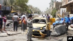 Iroq poytaxti Bag'dodning Sadr tumanidagi xurujda so'ng, 23-iyul, 2012-yil.