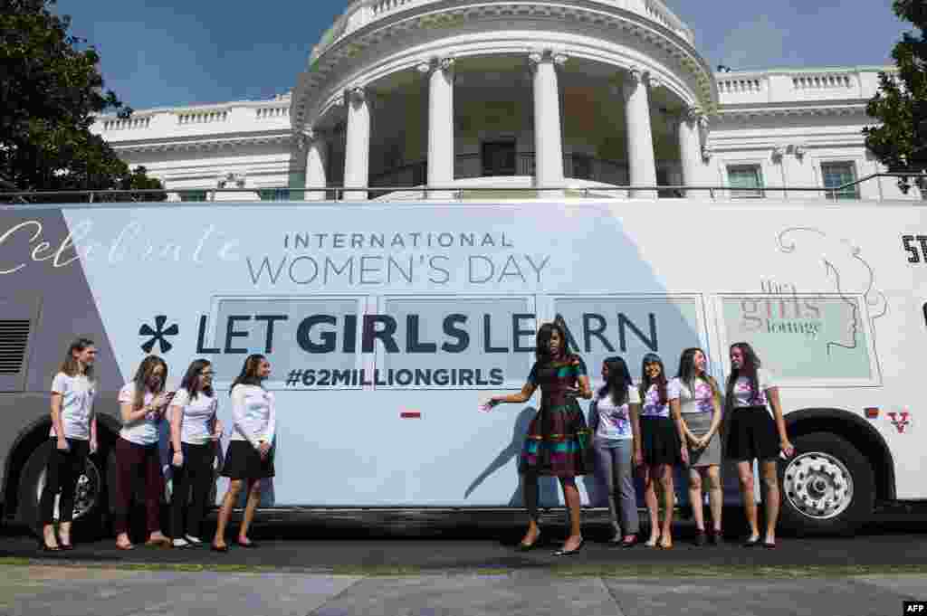 U.S. first lady Michelle Obama poses with young female students in front of the White House before an event to mark International Women's Day, as part of the first lady's Let Girls Learn initiative, in Washington, D.C., March 8, 2016.