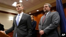 U.S. Attorney Thomas Cullen, left, speaks to the media along with FBI agent James Dwyer, right, after a plea agreement with James Alex Fields, who was charged with 30 counts stemming from a car attack in 2017, in Charlottesville, Va., March 27, 2019.