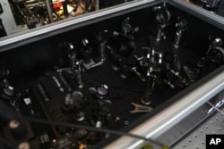 FILE - The inside of an optical box reveals the components that organize the light from laser beams to identify nanoplastics, microscopic plastic pieces, in New York on Monday, Jan. 8, 2024. (AP Photo/Mary Conlon)