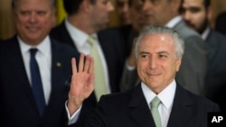 Brazil's acting President Michel Temer arrives to speak, at Planalto presidential palace in Brasilia, Brazil, Thursday, May 12, 2016.