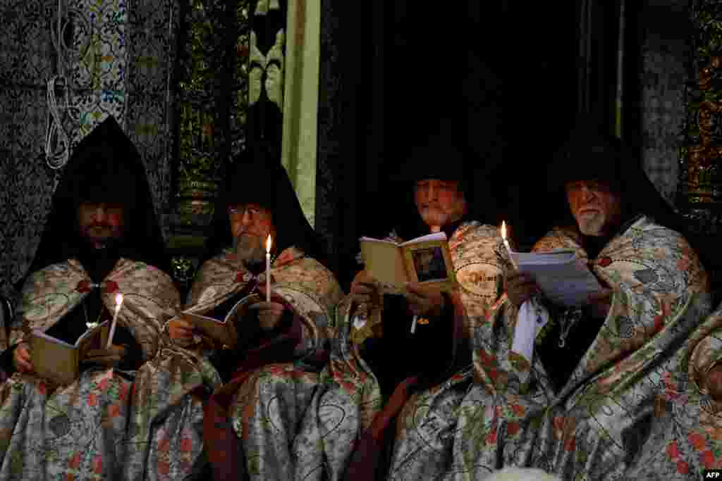 Armenian priests pray at the Armenian Saint James Cathedral in Jerusalem's Old City, ahead of the traditional Washing of the Feet ceremony during the Armenian Orthodox Holy Week.