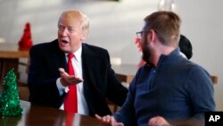 President Donald Trump meets retired U.S. Marine Corps Sgt. John Peck and his wife, Jessica, as Trump visits with wounded service members and their families at Walter Reed National Military Medical Center, Dec. 21, 2017, in Bethesda, Md. 