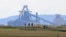FILE - People play golf near the Tata Steel plant in Hartlepool in north east England on May 3, 2021.