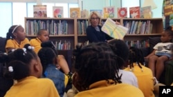 Education Secretary Betsy DeVos reads to students at Eagle Academy Public Charter School in Washington, June 2, 2017. DeVos strongly supporters charter schools and vouchers to help pay for private school for low-income Americans. (AP Photo/Maria Danilova)
