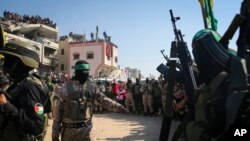 Wanamgambo wa Hamas na Islamic Jihad wakilinda eneo ambako kumefanyika ubadilishanaji wa mateka, Januari 30, 2025. Picha ya AP