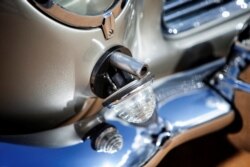 Handout photo of the detail of a gun turret shown in the front fender of an original Aston Martin DB5 James Bond car.