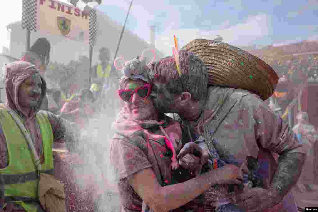 Revelers participate in 'flour war,' dousing each other with tons of colored flour, marking Clean Monday-the end of carnival season in the coastal town of Galaxidi, Greece.