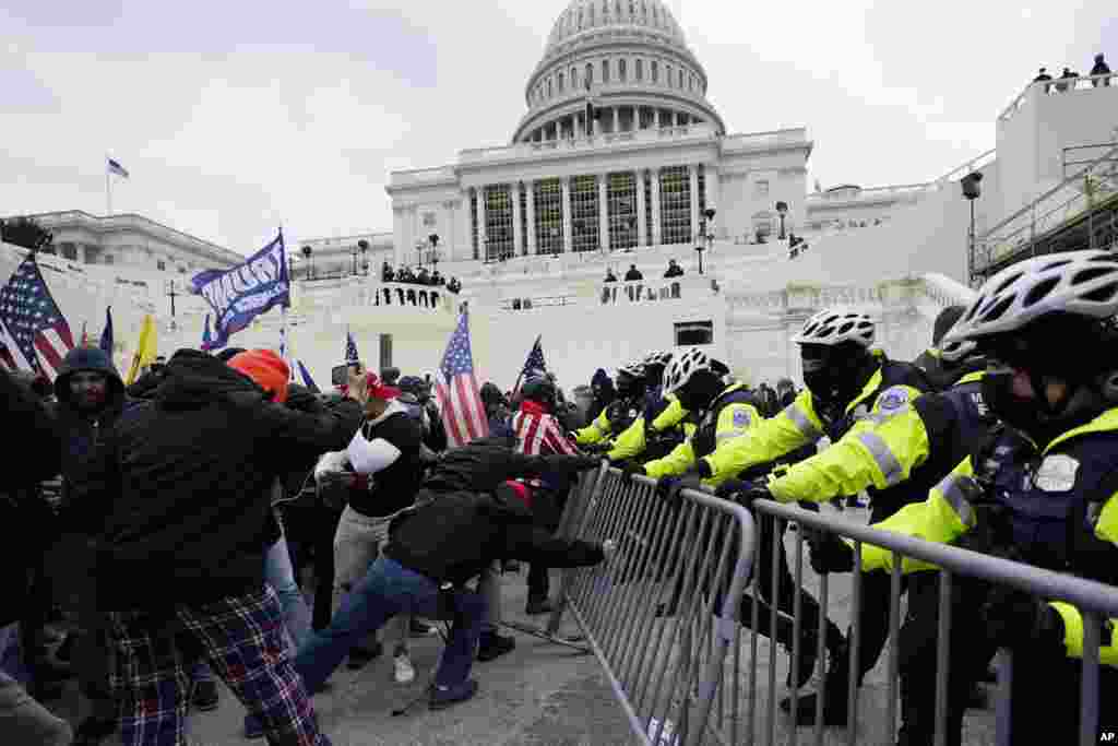 U.S. President Donald Trump's supporters try to break through a police barrier at the Capitol in Washington, D.C. as Congress prepares to affirm President-elect Joe Biden's victory.