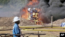 FILE- An oil well undergoes testing in the Lake Albertine region of western Uganda.