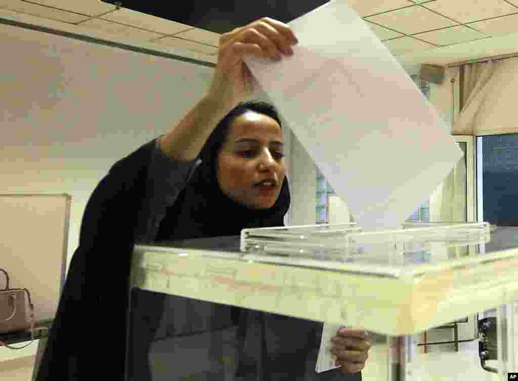 A Saudi woman casts her ballot at a polling center during municipal elections in Riyadh, Saudi Arabia, Dec. 12, 2015.