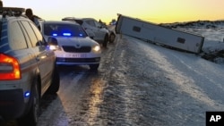 A bus lies on its side on a road near the Eldhraun lava field, about 250 kilometers (155 miles) east of Reykjavik, Iceland, Dec. 27, 2017.