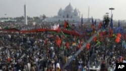 A baby orphaned elephant is fed milk from a bottle by a keeper, at an event to commemorate World Environment Day at the David Sheldrick Wildlife Trust Elephant Orphanage in Nairobi, Kenya.
