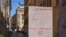 A hand written notice on the window of a shop advises that the shop will remain close for public health reason, concluding "All will be fine", in downtown Rome, March 12, 2020. 