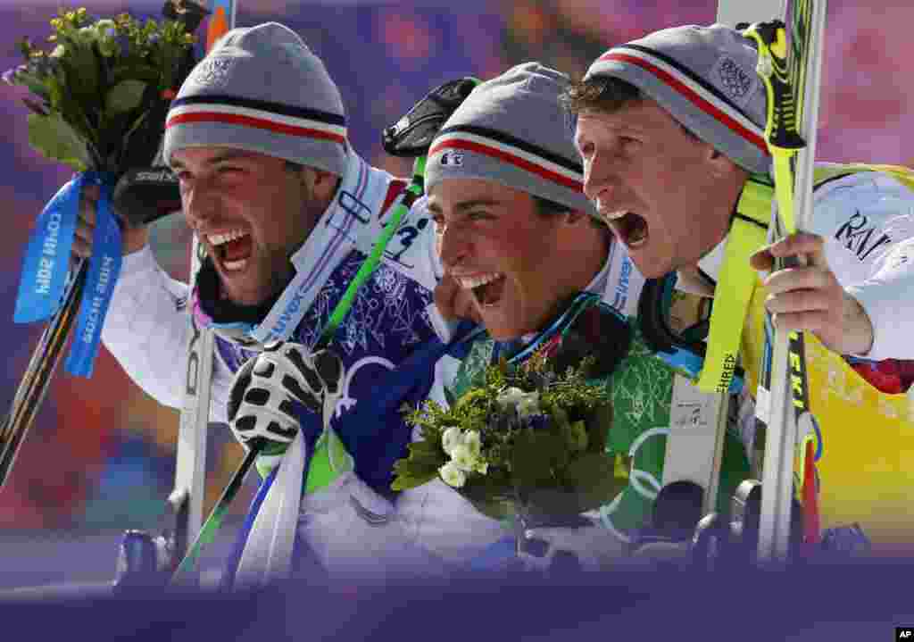 Men's ski cross gold medalist Jean Frederic Chapuis of France, center, celebrates with silver medalist Arnaud Bovolenta of France, left, and bronze medalist Jonathan Midol of France, at the Rosa Khutor Extreme Park, at the 2014 Winter Olympics, Krasnaya Polyana, Russia, Feb. 20, 2014. 