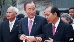 U.N. Secretary-General Ban Ki-moon (center) is escorted around the former security prison known as S-21 with a guide (right). The commandant of S-21, Comrade Duch, was convicted by the war crimes tribunal in Phnom Penh earlier this year.