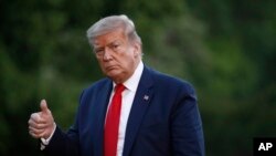 President Donald Trump gestures as he walks across the South Lawn of the White House in Washington, May 30, 2020.