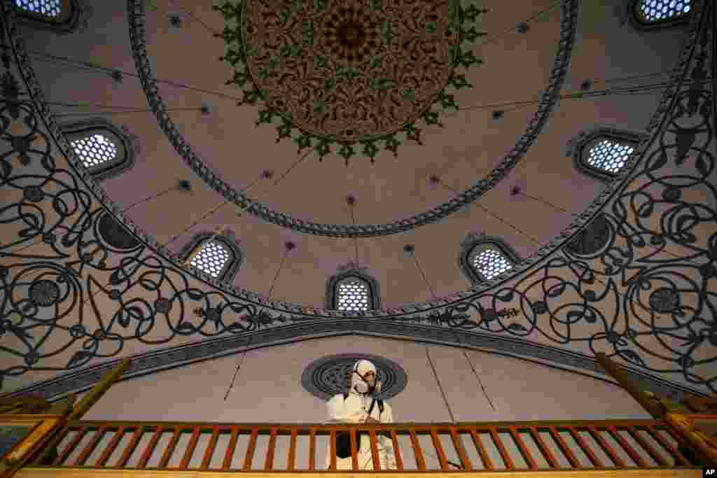 A disinfection team disinfects the premises of the grand mosque in capital Pristina, as Kosovo's mosques reopened after more than two months of the virus lockdown.