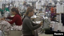 In this file photo taken on Dec. 12, 2018, employees work at a factory supplier of the H&M brand in Kandal province, Cambodia.