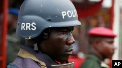 FILE - A police officer stand guards during a demonstration in Lagos, Nigeria, May. 1, 2014. An elite Nigerian police squad set up to combat violent crime is torturing detainees to extract lucrative bribes and confessions, an new Amnesty International rep