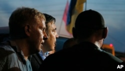Pro-democracy activists wave mobile phones with lights during a demonstration at Kaset intersection, in Bangkok, Thailand.