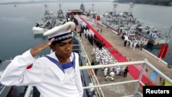 FILE- A Cambodian navy sailor salutes on a Chinese naval patrol boat during a handover ceremony at a Cambodian naval base at Ream in Sihanoukville province, southwest of Phnom Penh, on November 7, 2007. 