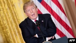 FILE - U.S. President Donald Trump attends a press conference at the White House in Washington, Jan. 10, 2018.