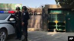 Visitors gather during a presentation visit of the "Grand Palais Ephemere", with the Eiffel Tower seeing outside, in Paris, France.