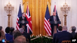 Britain's Prime Minister Keir Starmer, left, and U.S. President Donald Trump speak during a joint press conference in the East Room at the White House, Feb. 27, 2025, in Washington. 