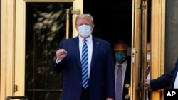 FILE - President Donald Trump walks out of Walter Reed National Military Medical Center to return to the White House after receiving treatments for COVID-19 in Bethesda, Md., Oct. 5, 2020.