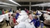 FILE - Employees work at a garment factory, a supplier for the H&M brand, in Kandal province, Cambodia, Dec. 12, 2018. 