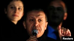 Turkey's Prime Minister Tayyip Erdogan addresses his supporters upon his arrival to Esenboga Airport in Ankara, Dec. 24, 2013.