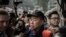 FILE - Outspoken media tycoon Jimmy Lai talks to the media after walking out of the Wanchai police station in Hong Kong, Jan. 21, 2015.