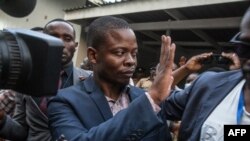Malawian preacher Shepherd Bushiri waves at supporters as he leaves the Lilongwe Magistrate court, in Lilongwe, Malawi, Nov. 19, 2020.