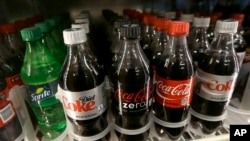 FILE - This Wednesday, Oct. 1, 2014, file photo, shows soft drinks for sale at K & D Market in San Francisco. Recently, Baltimore, Maryland, became the largest city in the United States to ban restaurants from including sodas and other sugary drinks on their menus for children.