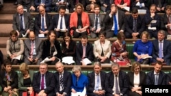 British Prime Minister Theresa May reacts during a no confidence debate after Parliament rejected her Brexit deal, in London, Britain, Jan. 16, 2019. 