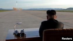 FILE - North Korean leader Kim Jong Un watches the launch of a Hwasong-12 missile in this undated photo released by North Korea's Korean Central News Agency (KCNA).