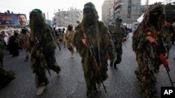 Masked Palestinian members of the Ezz Al-Din Al Qassam brigade, the military wing of Hamas in Gaza City, Nov. 14, 2013.