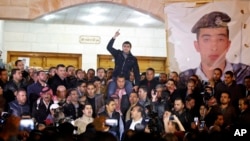 Supporters and family members of Jordanian pilot, Lt. Muath al-Kaseasbeh, express their anger of his reported killing, at the tribal gathering chamber, Amman, Jordan, February, 3, 2015. 
