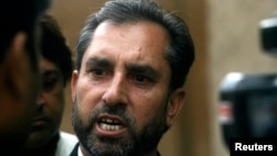 FILE - Samiullah Afridi, lawyer for Shakil Afridi, who ran a fake vaccination campaign to try help U.S. officials find al-Qaida chief Osama bin Laden, speaks to the media after appearing before the court in Peshawar.