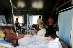 Un paciente que padece COVID-19 recibe máscara de oxígeno en la carpa médica del Poliedro de Caracas, el 21 de marzo de 2021.