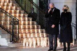 U.S. President Joe Biden and his wife Jill Biden attend a candle-lighting ceremony to commemorate the grim milestone of 00,000 U.S. deaths from COVID-19, at the White House, Feb. 22, 2021.