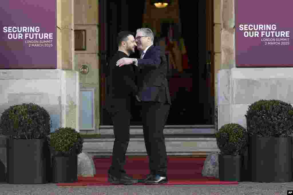 Britain's Prime Minister Keir Starmer, right, welcomes Ukrainian President Volodymyr Zelenskyy to the European leaders' summit to discuss Ukraine, at Lancaster House, London.