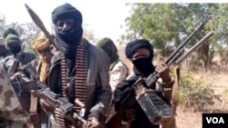 Members of a "bandit" gang pose with weapons at their forest hideout in northwestern Zamfara state, Nigeria, Feb. 22, 2021. 