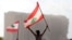 Demonstrators wave Lebanese flags during protests near the site of a blast at Beirut's port area, August 11, 2020.